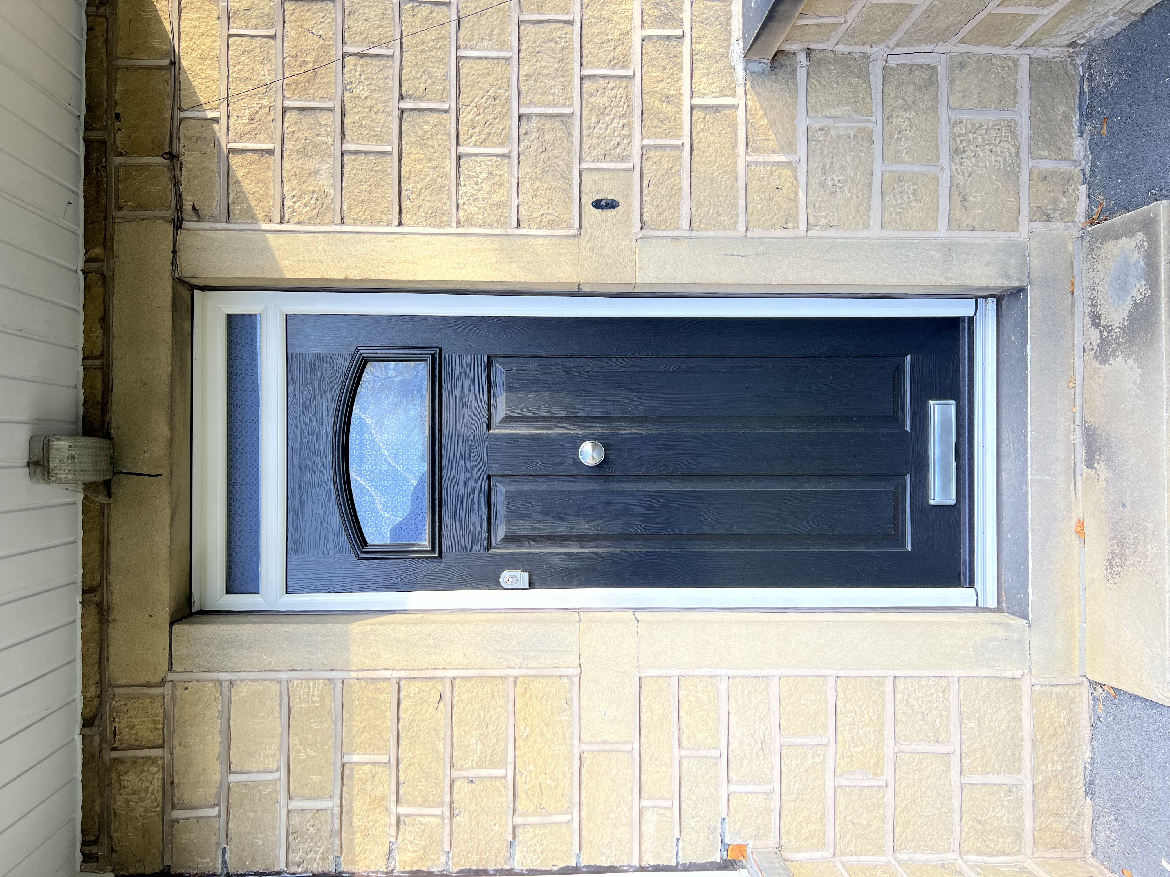 Black London composite door with Heritage handle and Canterbury glass